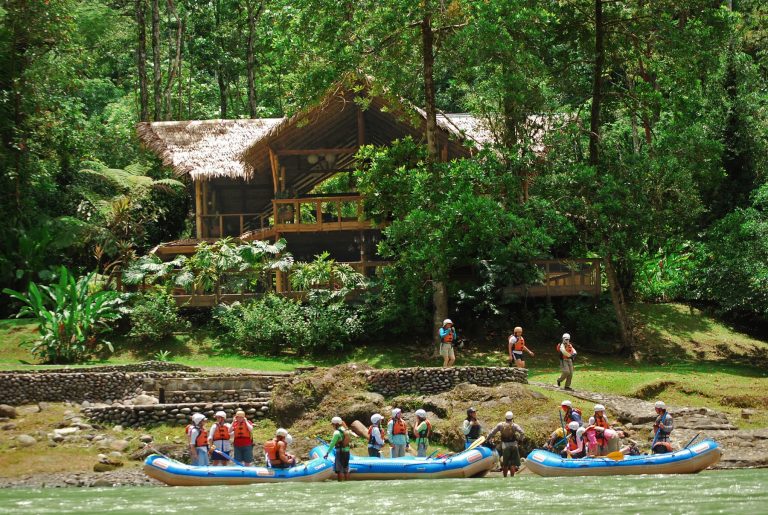 Rafting group near riverside lodge.