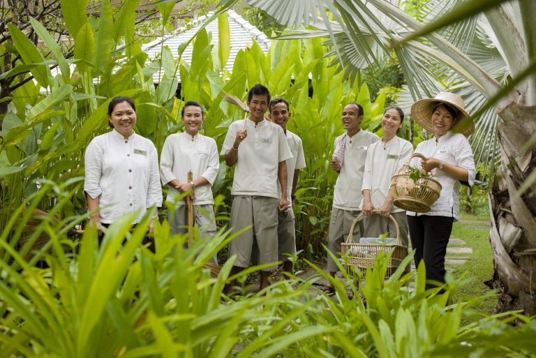 Group of Asian travel operators within plant greenery
