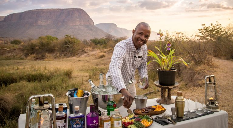 Outdoor gin tasting with scenic backdrop at Marataba South Africa